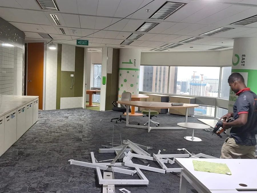 Reinstatement crew member at work clearing an office floor